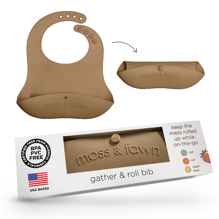 Silicone bib with packaging labeled 'moss & fawn' on a white background