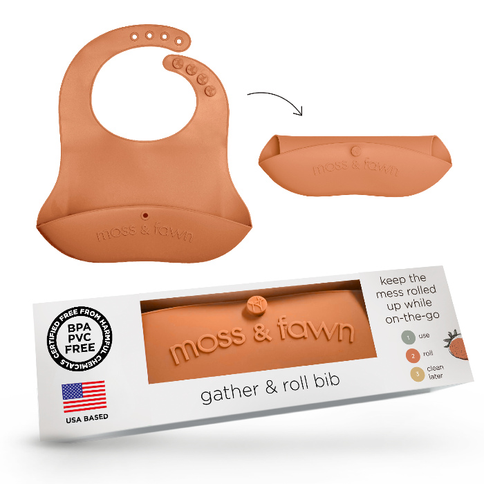 Silicone bib with packaging labeled 'moss & fawn' on a white background